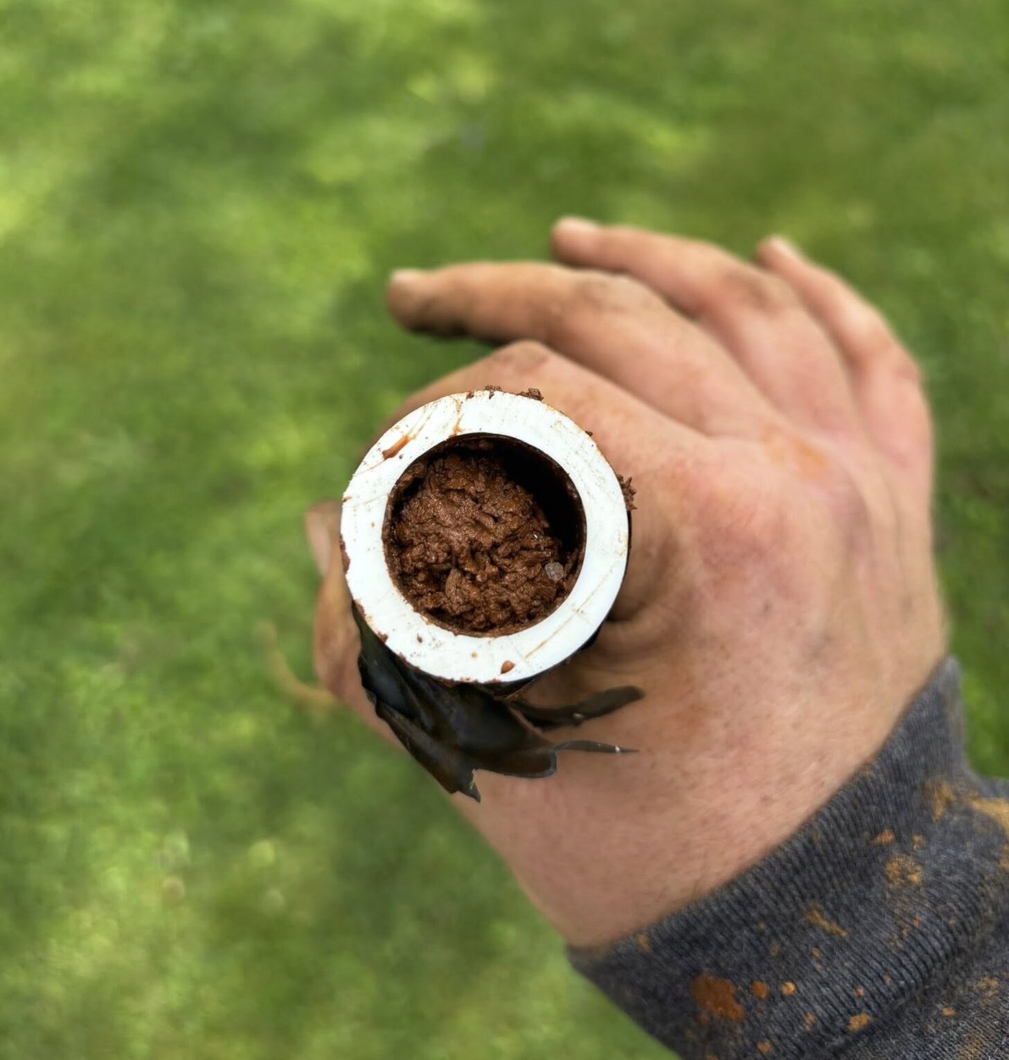 Glass of rusty sediment-filled well water showing a common private well water quality issue